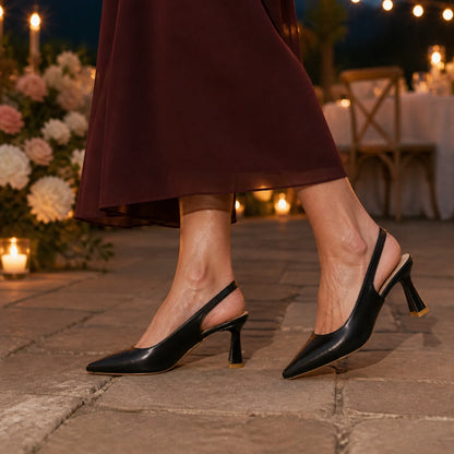Mature woman wearing black slingback wedding guest shoes outdoors at an evening reception — view 7