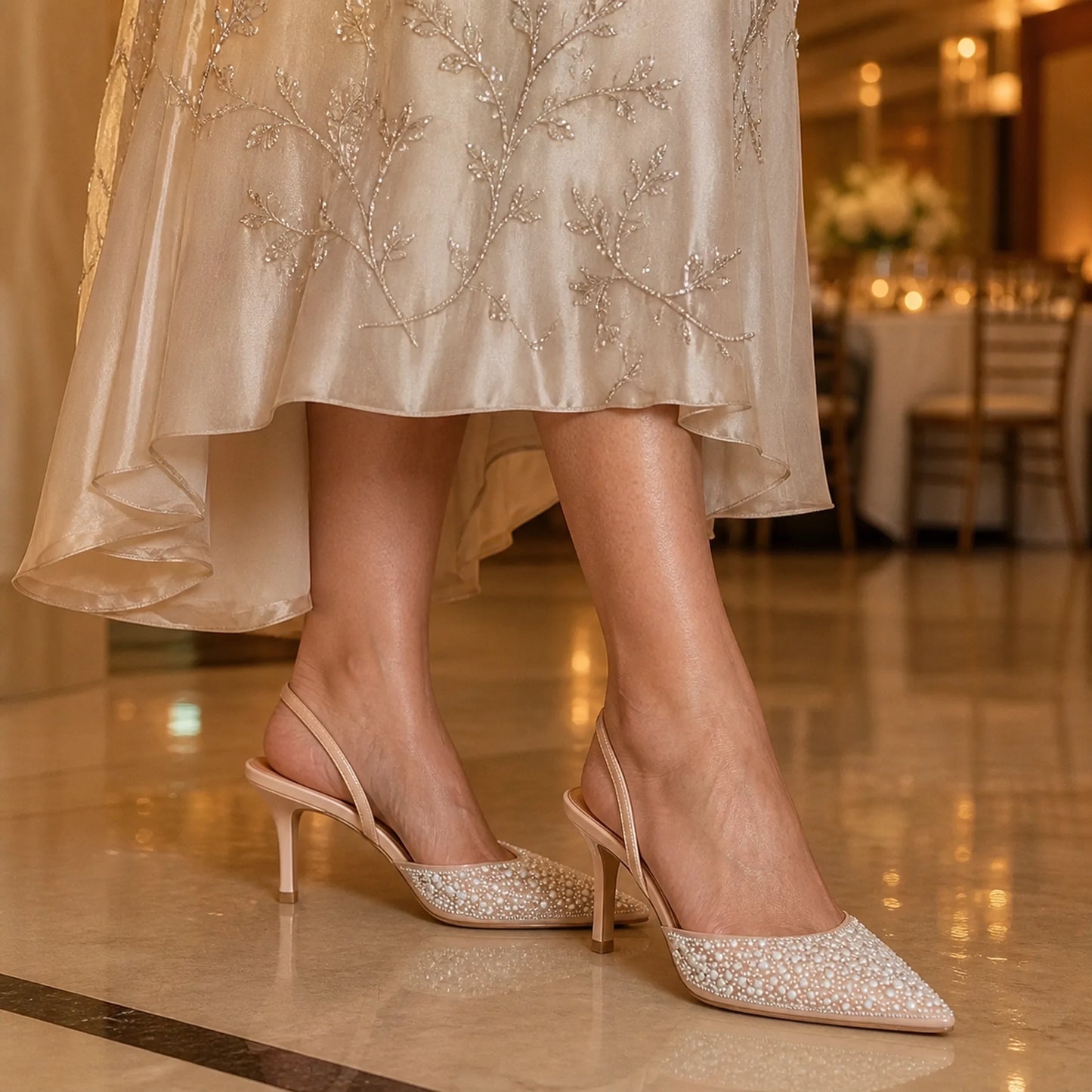 wedding guest shoes — Mature woman wearing nude ivory pearl slingback shoes indoors — view 6