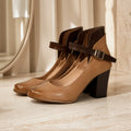 wedding guest shoes — Marisol brown classic Mary Jane block heel pumps — complete three quarter front view