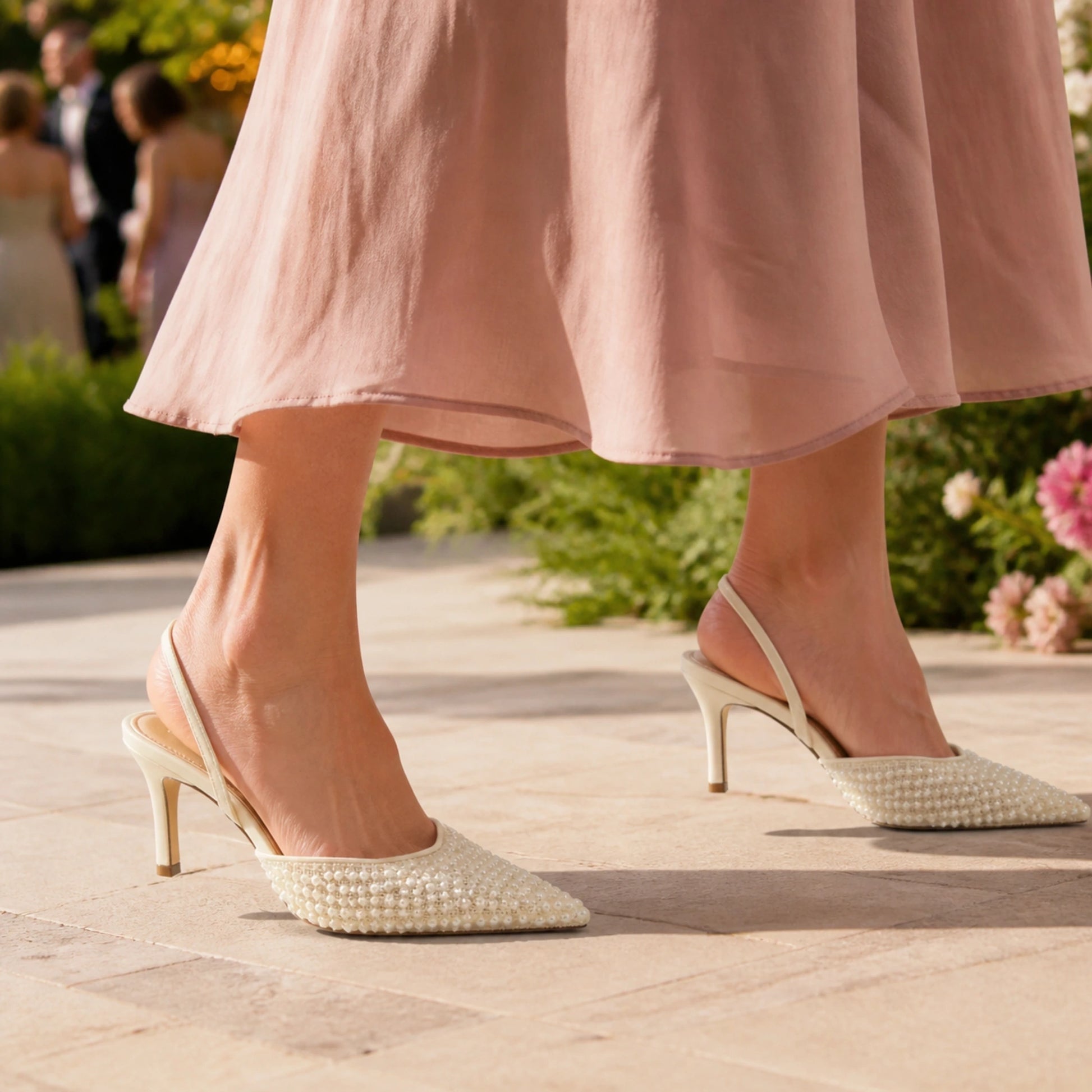 Mature woman wearing ivory pearl slingback wedding guest shoes outdoors — view 7