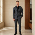 Dark gray slim fit wedding guest suit, complete front view on mature male model