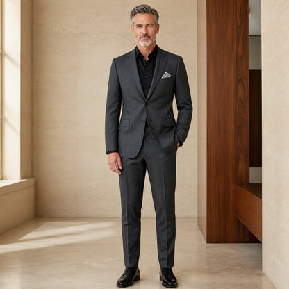 Dark gray slim fit wedding guest suit, complete front view on mature male model